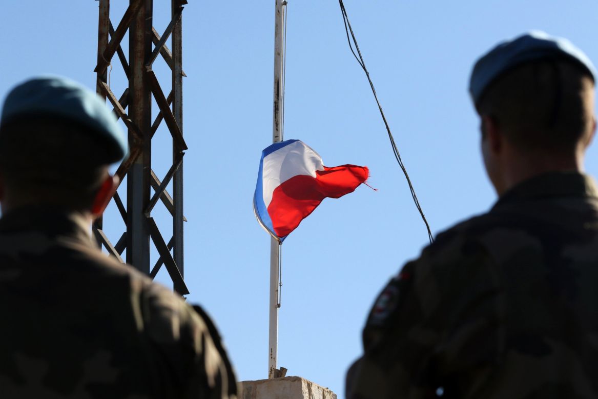 French soldiers of the United Nations' interim forces in Lebanon observe the national flag at half-staff at the contingent headquarters in the village of Deir Kifa on November 14.