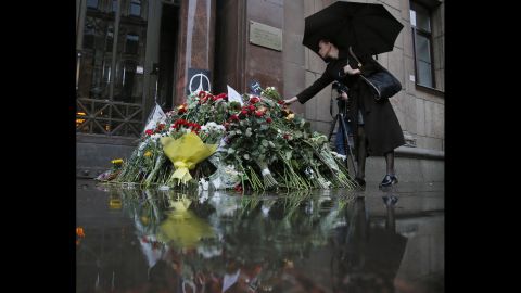 A woman places flowers in front of the French Consulate in St. Petersburg, Russia, on November 14.