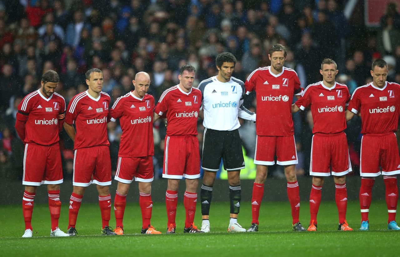 David Beckham (far left) and his Great Britain & Ireland team observe a silence in honor of the victims of the Paris attacks. Beckham's team played a Rest of the World selection at Old Trafford in aid of UNICEF. 