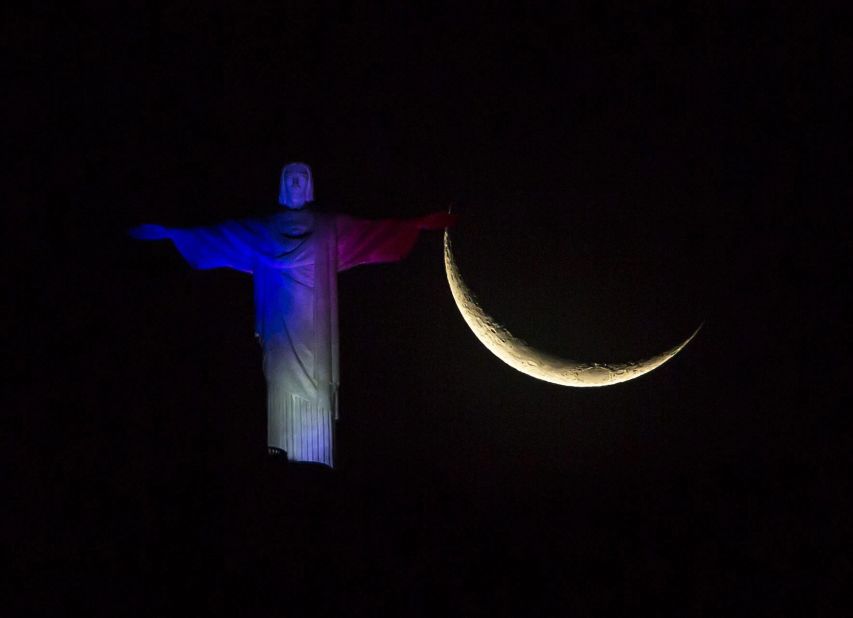 The Christ the Redeemer statue in Rio de Janeiro is illuminated in French national colors on November 14.