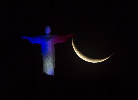 The Christ the Redeemer statue in Rio de Janeiro is illuminated in French national colors on November 14.