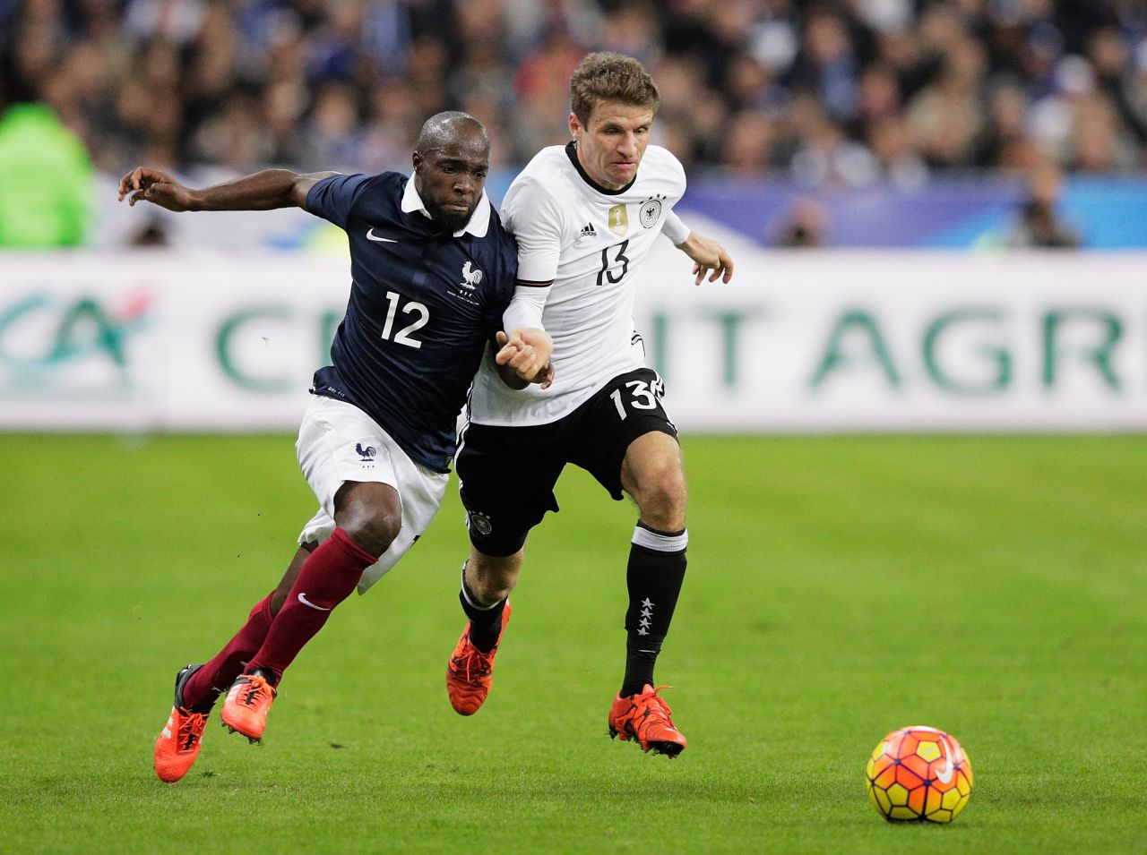 Lassana Diarra (No 12) tussles with Thomas Mueller of Germany during the match at the Stade de France. Diarra later revealed that his cousin had been a victim of the attacks in Paris. 