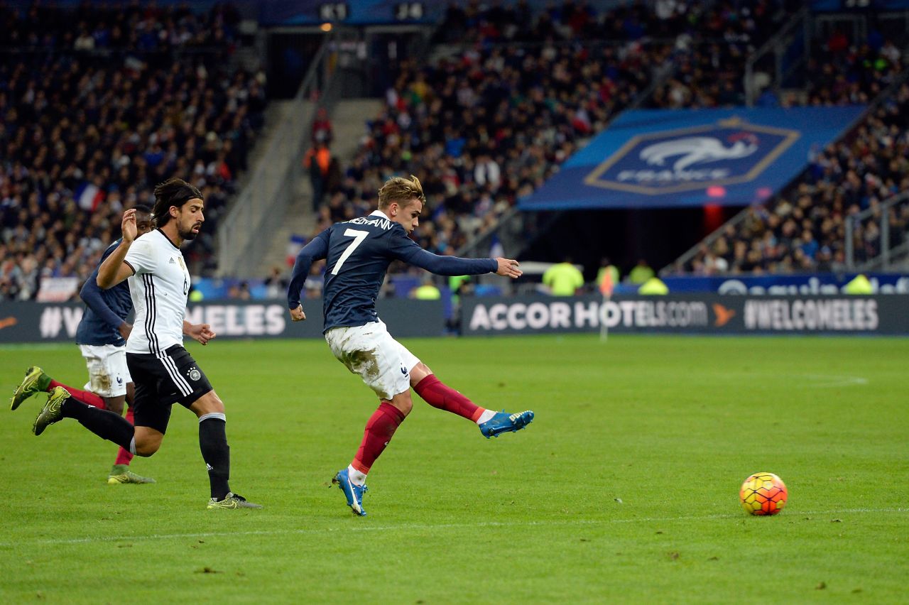 French midfielder Antoine Griezmann sends in a shot during the match. Griezmann's sister survived the attack at the Bataclan threatre while he was playing for his country.   