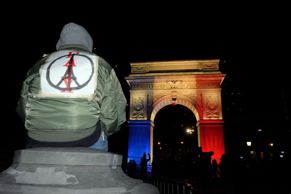 French graphic designer Jean Jullien's image of 'Peace for Paris' (the combination of a peace sign and an Eiffel Tower), has spread across the world, as people have adopted it to show support for French citizens, following a spate of deadly attacks in Paris on November 13. The Washington Square Park arch in New York is lit with the French national colors. This New Yorker wears the 'Peace for Paris' symbol on his back. 