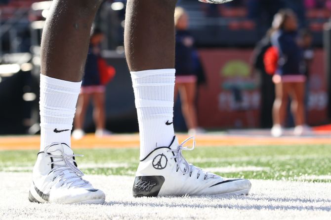 Ohio State Buckeyes quarterback Cardale Jones is shown wearing a Paris peace symbol drawn on his cleat during the first half of an NCAA football game against the Illinois Fighting Illini in Champaign, Illinois.