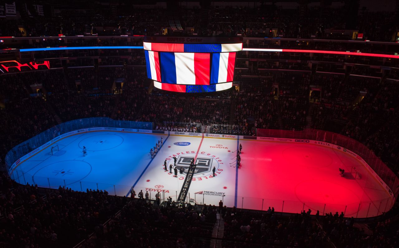 The Staples Center's ice is lit up with the colors of the French flag before the start of an NHL hockey game on November 14.