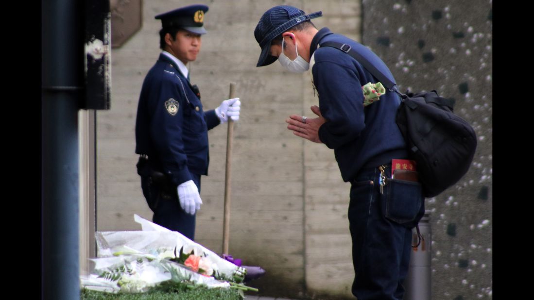 A man offers a prayer in memory of victims of the Paris attacks at the French Embassy in Tokyo on November 15. 