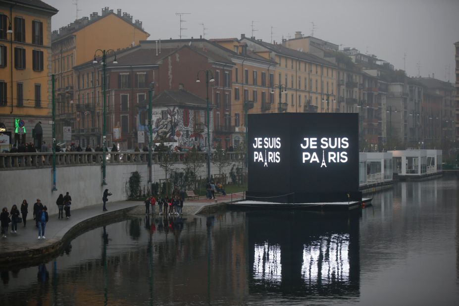 An electronic billboard on a canal in Milan, Italy reads, in French, "I'm Paris," on November 14.