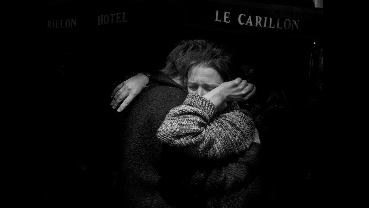 The day after the terror attacks in Paris on Friday, November 13, Magnum photographer Alex Majoli photographed the range of responses to the tragedy. This image of two people embracing and crying in front of Le Carillon, the bar where gunmen drove by and opened fire with Kalashnikov-type assault rifles, is especially important to him. "Many times when I come to Paris ... that is the bar where usually I have my last drink before I go to bed," Majoli said.<br />