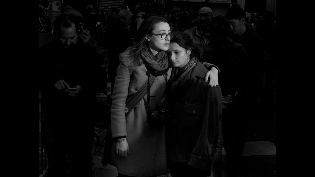 Two girls stand in front of the Bataclan music venue where men with AK-47 assault rifles opened fire. Majoli was with a friend just two blocks away from the Bataclan the night of the attacks. <br />