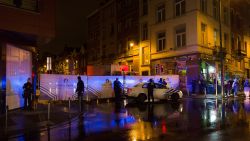 Belgian police cordon off a street during a police raid in connection with the November 13 deadly attacks in Paris, in Brussels' Molenbeek district on November 14, 2015. Several people were arrested in Brussels on November 14 during police raids connected to the attacks in Paris, Belgian Justice Minister Koen Geens said. Geens said on RTBF television that these arrests in the capital's Molenbeek neighbourhood "can be seen in connection with a grey Polo car rented in Belgium" found near the concert hall in the French capital where scores of people were killed. AFP PHOTO / BELGA / JAMES ARTHUR GEKIERE = BELGIUM OUT =        (Photo credit should read JAMES ARTHUR GEKIERE/AFP/Getty Images)