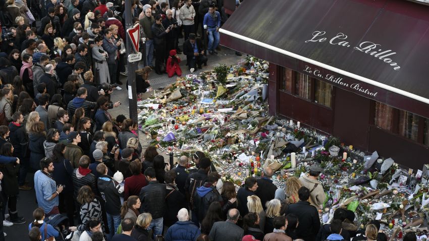 People gather at a makeshift memorial in front of "Le carillon" restaurant on November 16, 2015, in the 10th district of Paris, following a series of coordinated terrorists attacks on November 13. Islamic State jihadists claimed a series of coordinated attacks by gunmen and suicide bombers in Paris that killed at least 128 people in scenes of carnage at a concert hall, restaurants and the national stadium. AFP PHOTO / ALAIN JOCARD        (Photo credit should read ALAIN JOCARD/AFP/Getty Images)