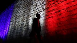 An Israeli Ultra Orthodox Jewish man walks past Jerusalem's Old City  Ottoman Walls illuminated in red, white and blue, the colors of the French flag, in Jerusalem on November 15, 2015 in solidarity with France and the attacks in Paris. Islamic State jihadists claimed a series of coordinated attacks by gunmen and suicide bombers in Paris that killed at least 129 people in scenes of carnage at a concert hall, restaurants and the national stadium Paris.  AFP PHOTO/GALI TIBBON        (Photo credit should read GALI TIBBON/AFP/Getty Images)