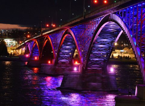 The Peace Bridge, which connects Canada and the United States, glows with the colors of the French flag November 14 in Buffalo, New York.