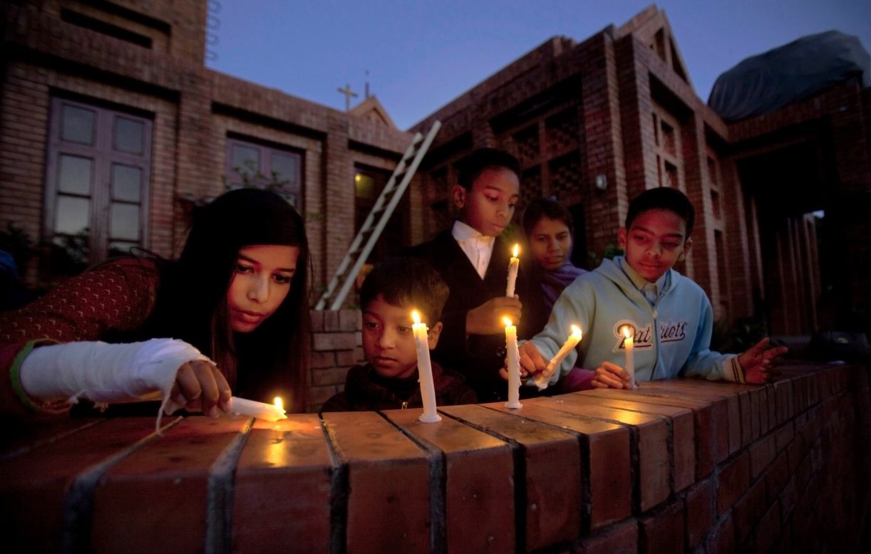 People pray during a candlelight vigil for victims of the Paris attacks at a church in Islamabad, Pakistan, on November 15. 
