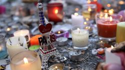 Candles and a small statue of the Eiffel Tower are placed at a memorial along a police cordon set-up close to the Bataclan concert hall on November 15, 2015, two days after a series of deadly attacks. Islamic State jihadists claimed a series of coordinated attacks by gunmen and suicide bombers in Paris on November 13 that killed at least 128 people in scenes of carnage at a concert hall, restaurants and the national stadium. AFP PHOTO / MIGUEL MEDINA        (Photo credit should read MIGUEL MEDINA/AFP/Getty Images)