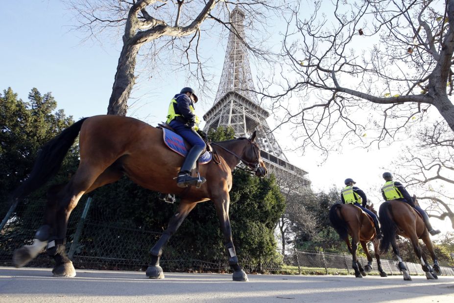 Mounted police officers patrol in front of the Eiffel Tower in Paris on November 15. 