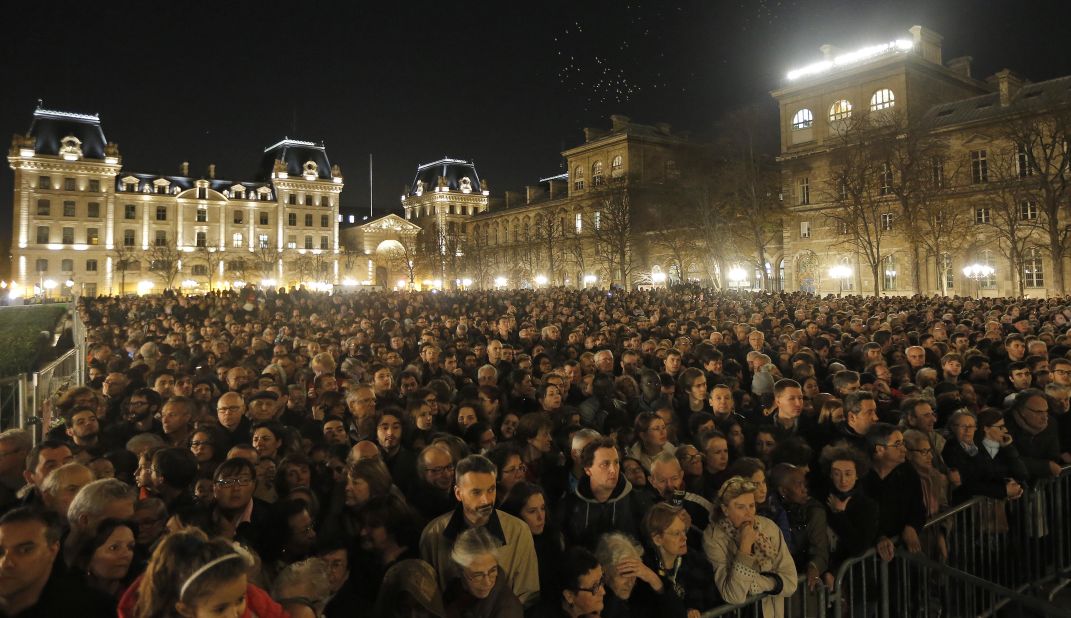 People gather outside Notre Dame Cathedral in Paris on November 15 for a national service for the victims of the city's terror attacks.