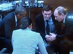 President Barack Obama, Russian President Vladimir Putin and aides huddle at a G20 summit on November 15, 2015.