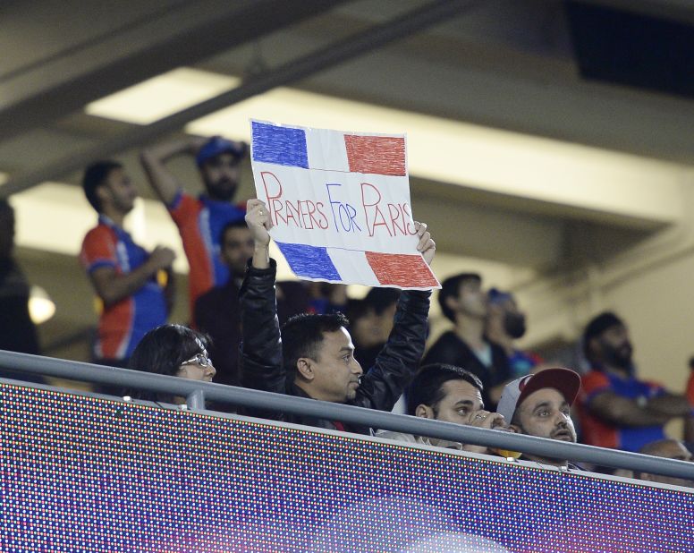 A fan holds up a sign in honor of the victims at the US tour of Cricket All-Stars Series.