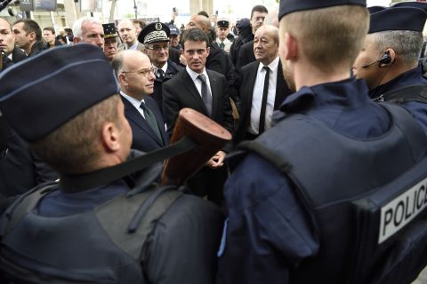 French Prime Minister Manuel Valls, center, speaks with police forces with French Interior minister Bernard Cazeneuve, left, and Defence Minister Jean-Yves Le Drian at the Gare du Nord railway station in Paris on November 15 about security measures after the attacks.