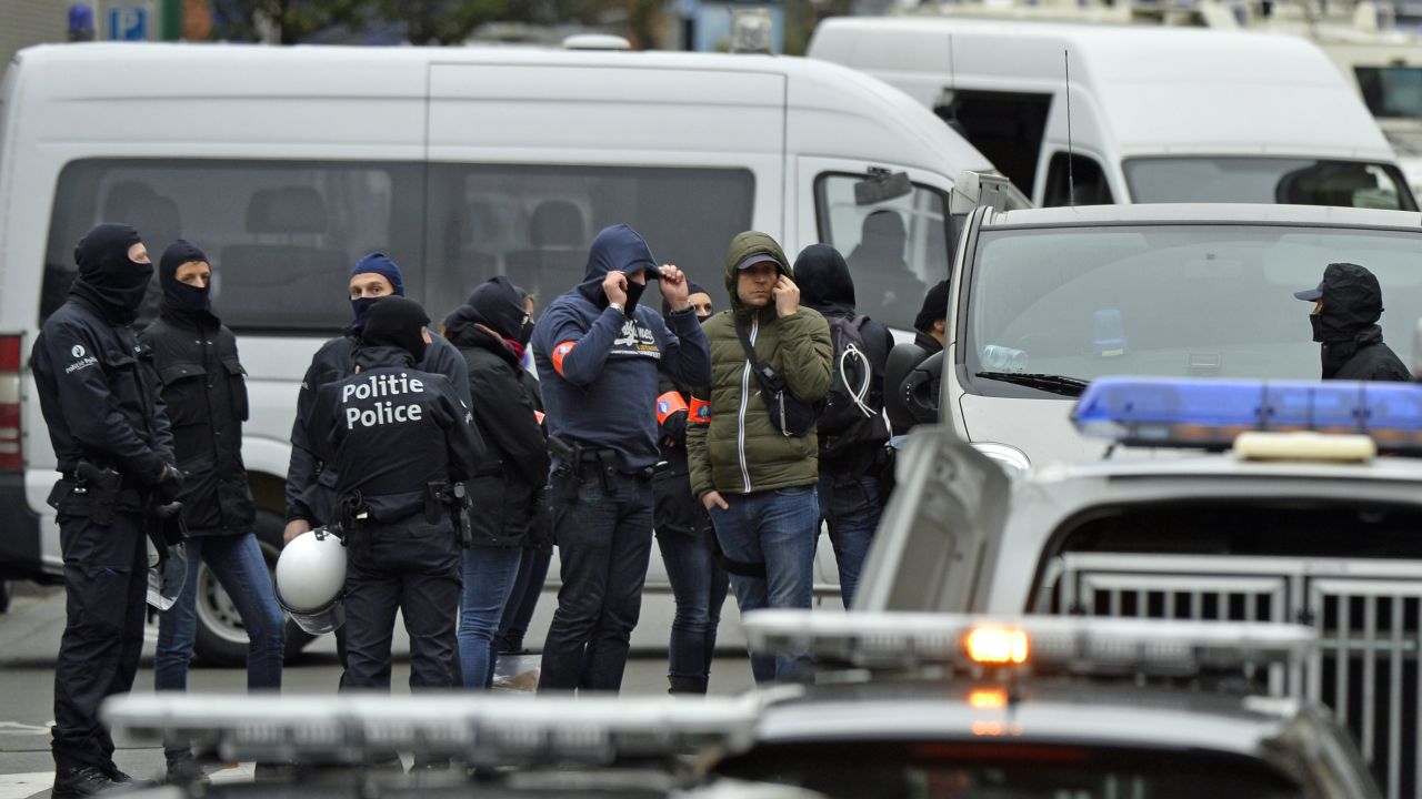 Police officers man a cordon as an operation takes place in the Molenbeek district of Brussels on November 16, 2015. Belgian police launched a major new operation in the Brussels district of Molenbeek, where several suspects in the Paris attacks had previously lived, AFP journalists said. Armed police stood in front of a police van blocking a street in the run-down area of the capital while Belgian media said officers had surrounded a house. Belgian prosecutors had no immediate comment.