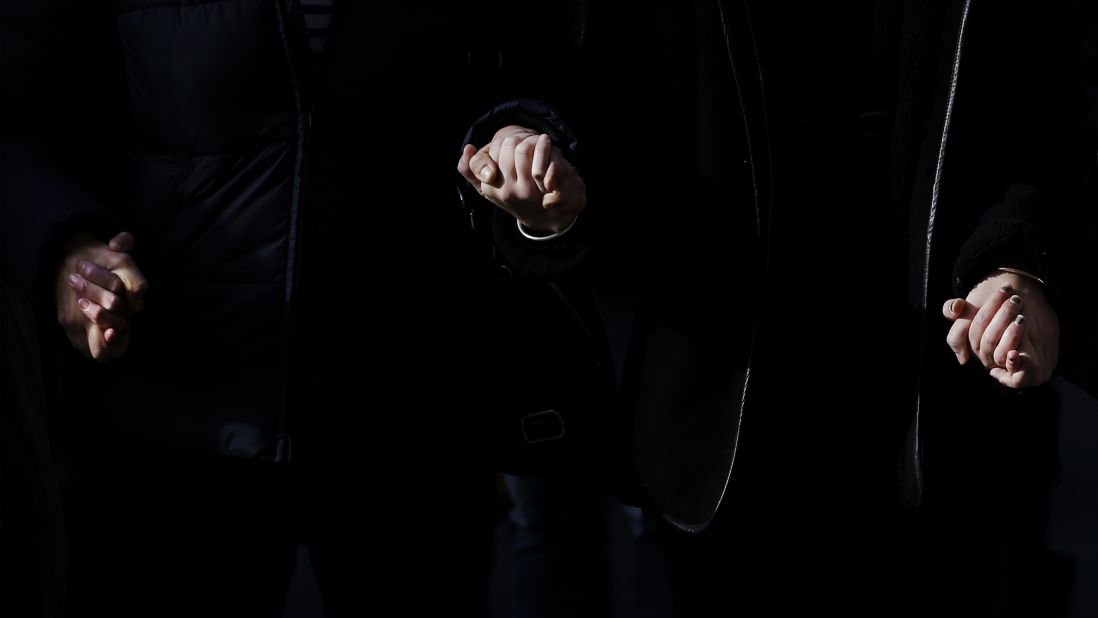 People hold hands as they observe a minute of silence in Lyon, France, on November 16, three days after the Paris attacks. A minute of silence was observed throughout the country in memory of the victims of the country's deadliest violence since World War II.