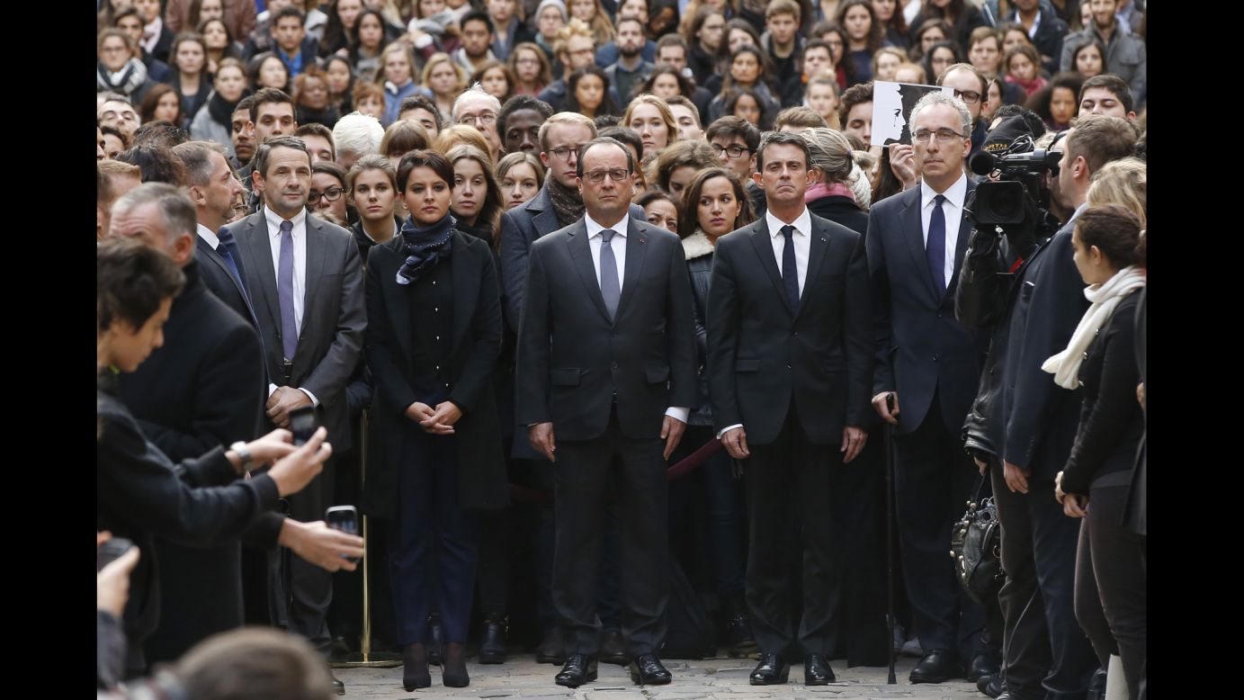 French President Francois Hollande, center, flanked by French Prime Minister Manuel Valls, right, and French Education Minister Najat Vallaud-Belkacem, center left, stands among students during a minute of silence in the courtyard of the Sorbonne University in Paris on November 16.