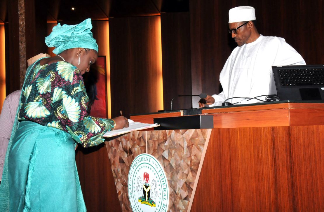 Finance minister Kemi Adeosun  signs the register before Nigerian President Mohammadu Buhari after taking the oath of office.