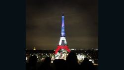 The Eiffel Tower is lit up with the colors of France