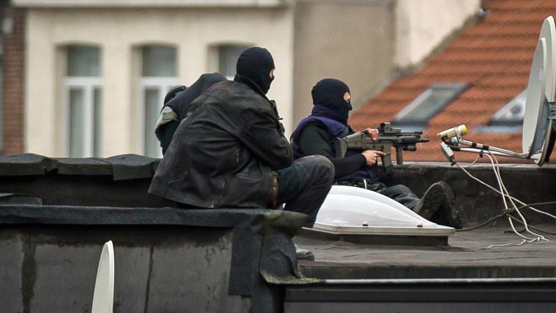 Special forces stand guard on a roof in Molenbeek, a suburb of Brussels, Belgium, on Monday, November 16.