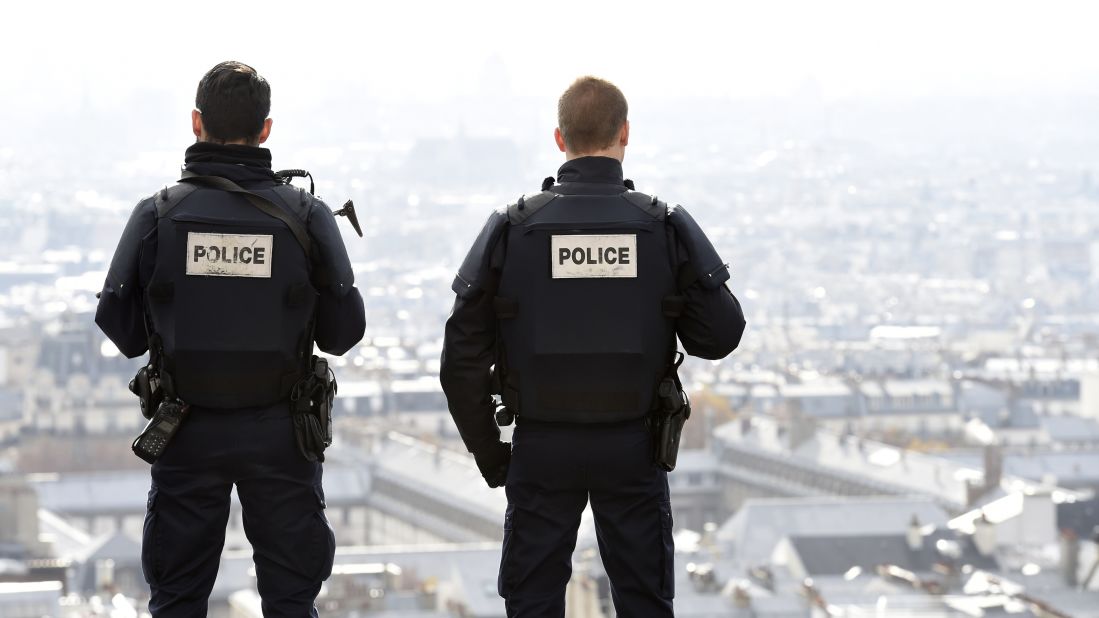 Police officers overlook Paris as they patrol in front of the Sacre Coeur Basilica on November 16.
