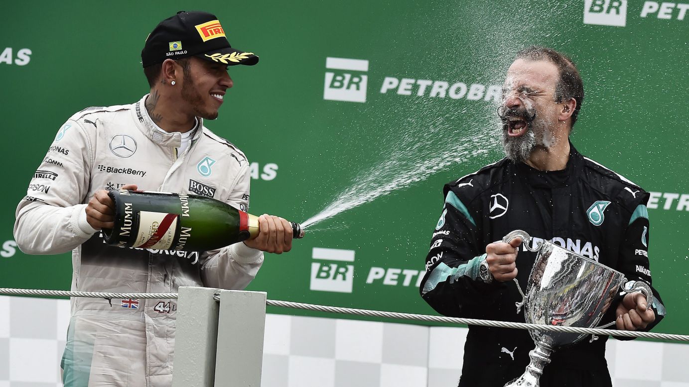 Formula One driver Lewis Hamilton sprays his team's mechanic, James Waddell, after finishing second at the Brazilian Grand Prix on Sunday, November 15. Hamilton's Mercedes teammate, Nico Rosberg, won the race.