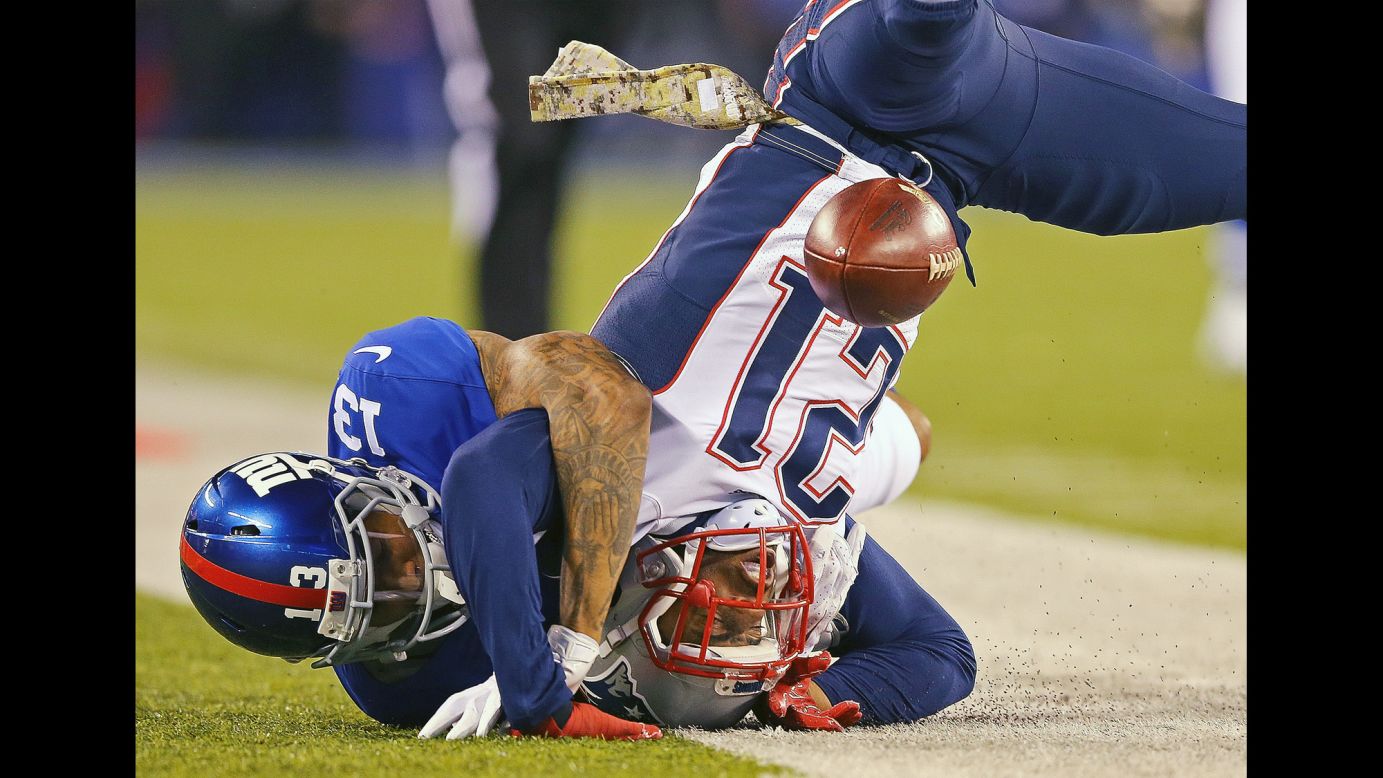 New England Patriots cornerback Malcolm Butler, right, slams into the turf after breaking up a pass intended for Odell Beckham Jr., left, during an NFL game in East Rutherford, New Jersey, on Sunday, November 15.