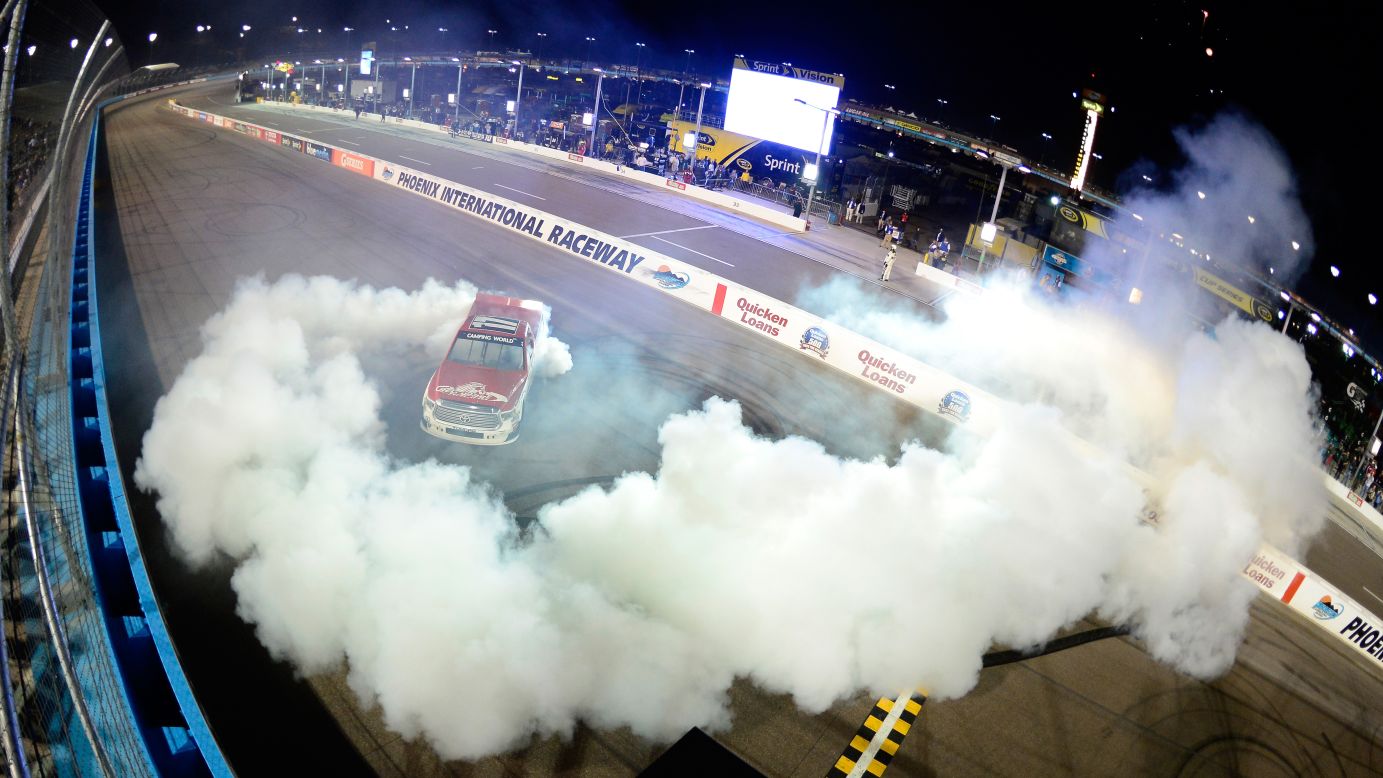 NASCAR driver Timothy Peters celebrates with a burnout after winning the truck race at Phoenix International Raceway on Friday, November 13. It was his second victory of the season.