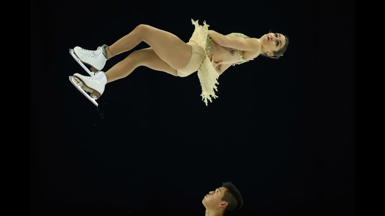 Figure skater Marissa Castelli spins in the air as she and her partner, Mervin Tran, at the Grand Prix event in Bordeaux, France, on Friday, November 13. The event was later canceled in light of the Paris terror attacks.