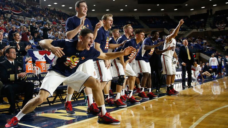 Basketball players on Navy's bench celebrate a made shot Friday, November 13, during a game against Florida in Annapolis, Maryland.