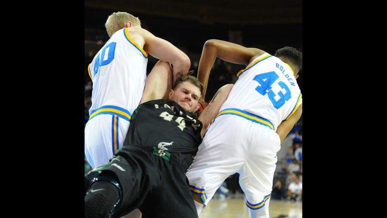 Cal Poly's Zach Gordon is tied up by UCLA's Thomas Welsh and Jonah Bolden during a basketball game in Los Angeles on Sunday, November 15.