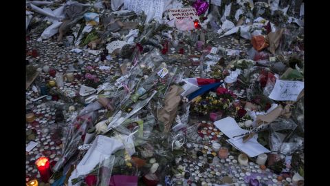 A memorial commemorates the victims of the Paris attacks on a street in Paris on Monday, November 16.