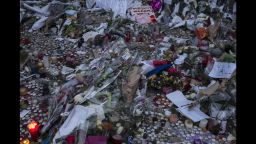 A memorial commemorates the victims of the Paris attacks on a street in Paris, France on Monday, November 16.