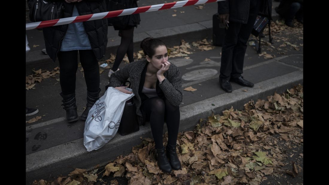 A woman on November 16 sits in front of the Parisian concert venue Balaclan, where many of the victims from the Paris attacks were killed. 