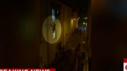 paris attacks woman hanging from window ledge cooper dnt ac _00002405.jpg