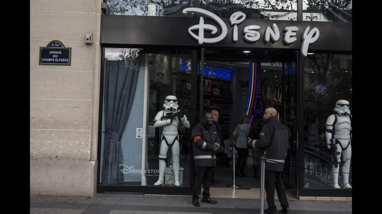 Security guards stand outside a Disney store on Champs Elysees in Paris on November 16. 