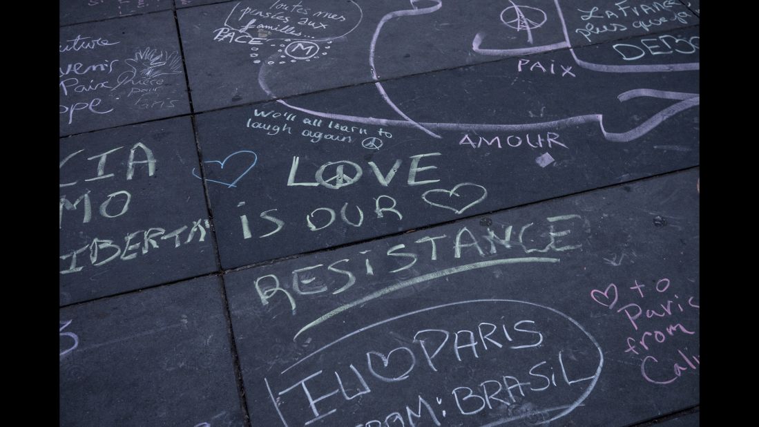Comments made with different colored chalk are written on the Place de la Republique in Paris on November 16.