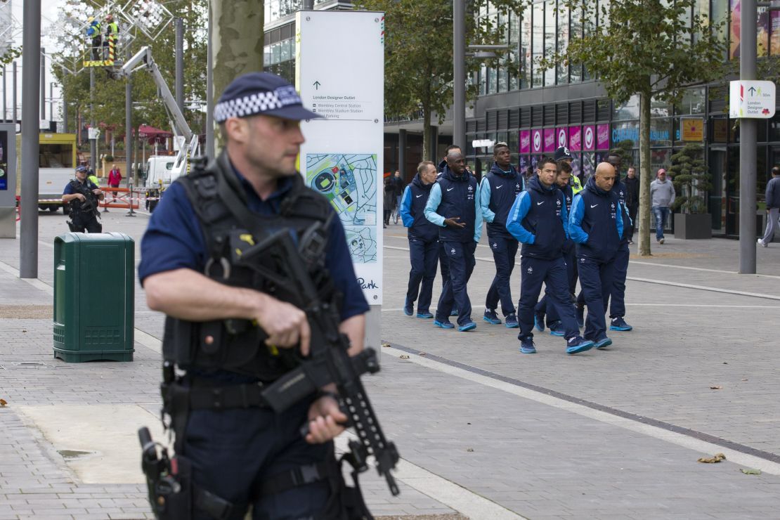 Players and staff of the France football team go for a morning walk-about escorted by British armed police around Wembley Stadium, ahead of their international friendly football match against England.