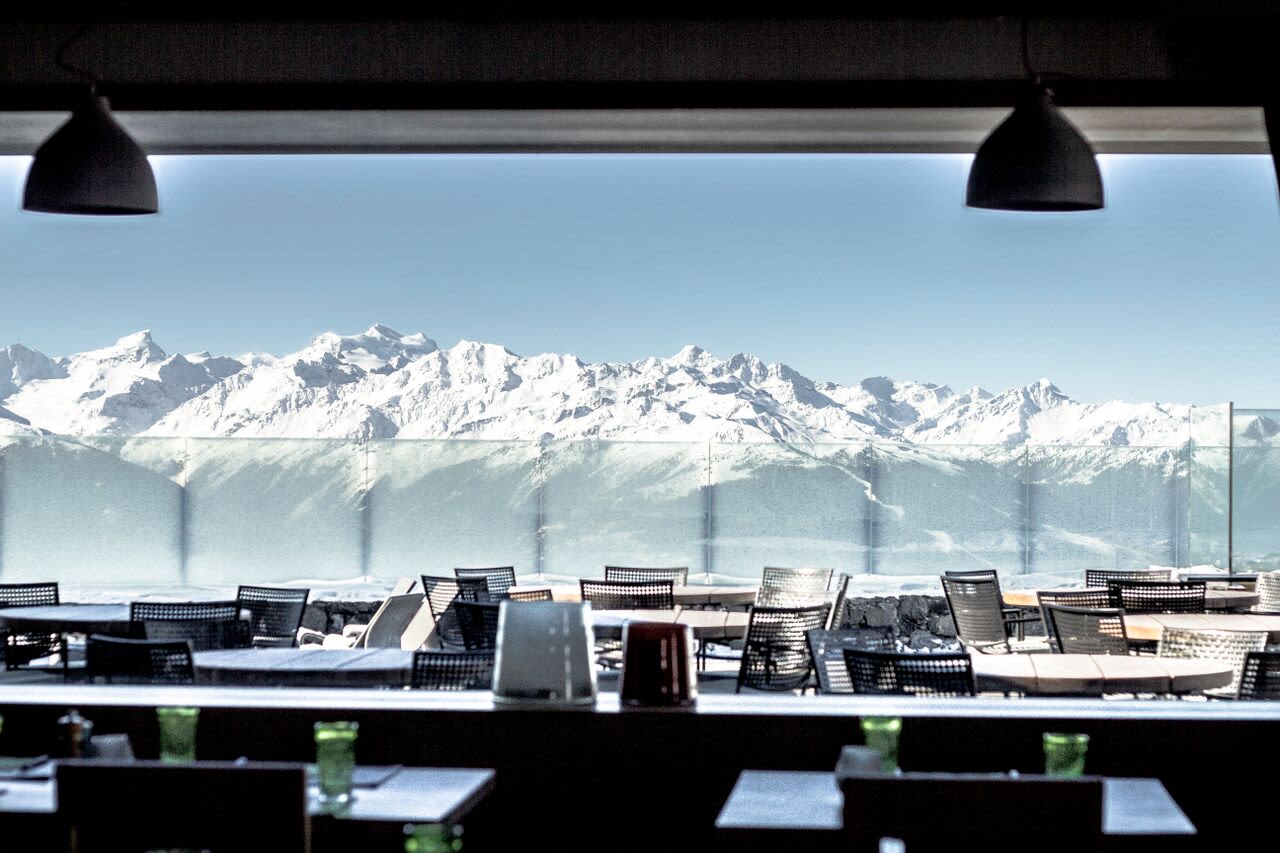 Hotel Chetzeron's huge restaurant windows reveal snow-covered Alpine peaks.