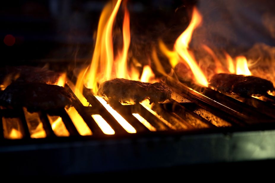 The uncontrollable heat and flames of a barbecue sometimes lead to uncooked burgers; always make sure they are well-done to avoid an upset stomach.