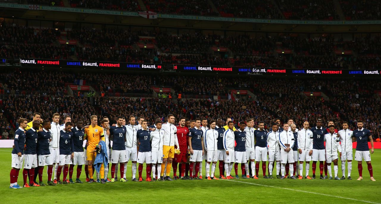 England and France players pose for a moment of applause prior to the international friendly match at Wembley Stadium on November 17, 2015. 