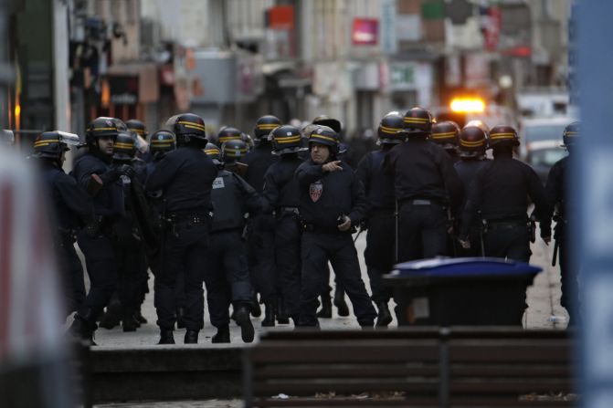 Police take positions during the raid.