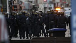 Policemen take combat position in Saint-Denis city center, northern Paris on Wednesday as French Police special forces raid an apartment targeting suspects in last week's terrorist attacks. 